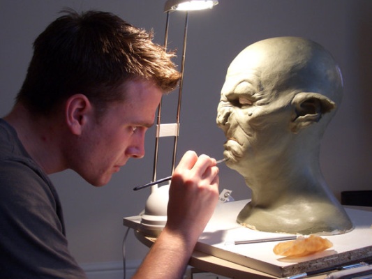 Luke McNally scuplting an Orc head